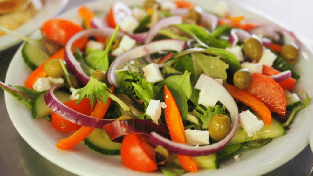 greek salad with feta cheese, tomatoes, cucumbers, olives and feta