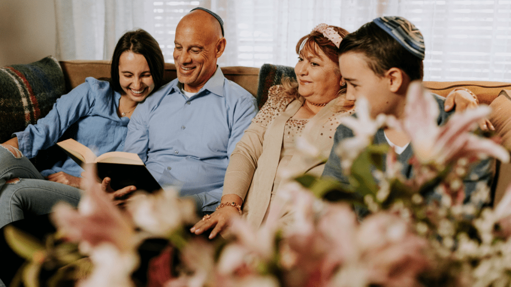 A family sitting on a couch in a living room