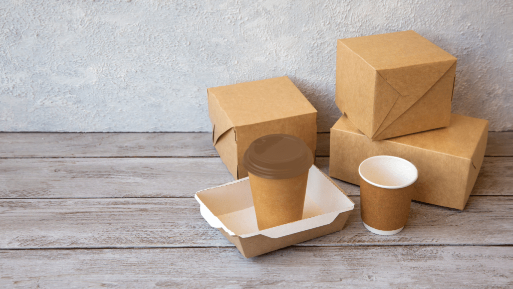 takeout boxes and coffee cups on a wooden table