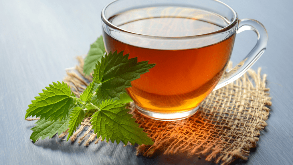 herbal tea with mint leaves in a glass cup on a wooden surface