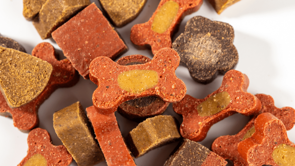 a pile of dog treats on a white surface