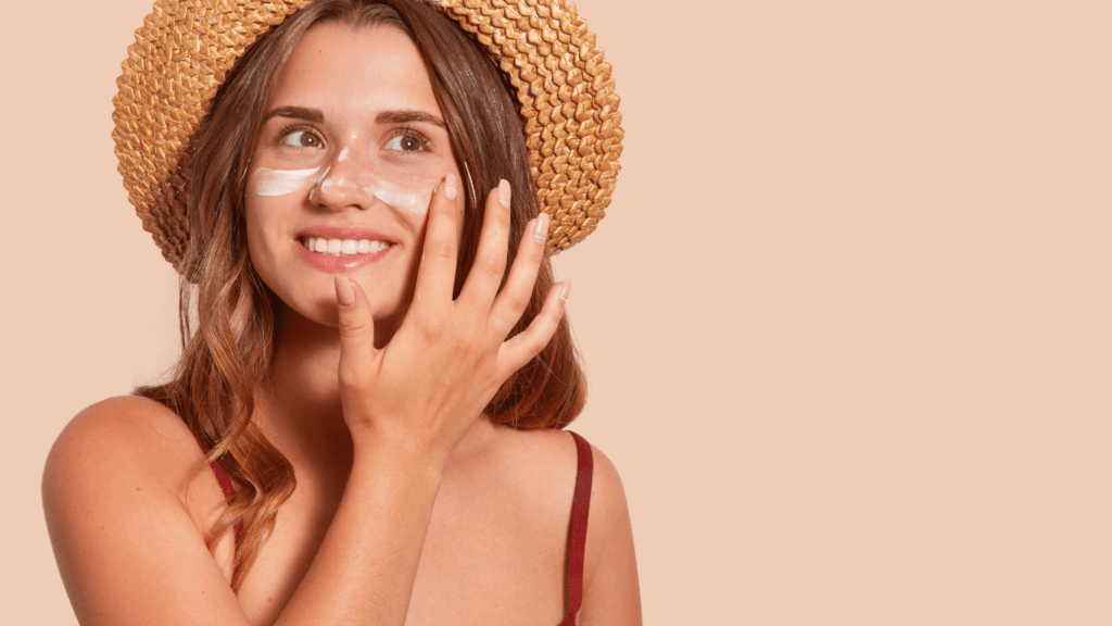 a person applying cream to their face on the beach