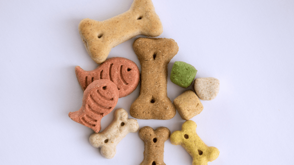 a pile of dog treats on a white surface