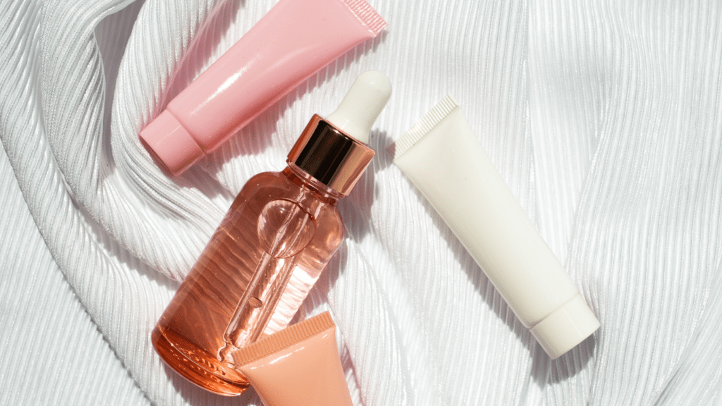 pink cosmetic products on a white cloth