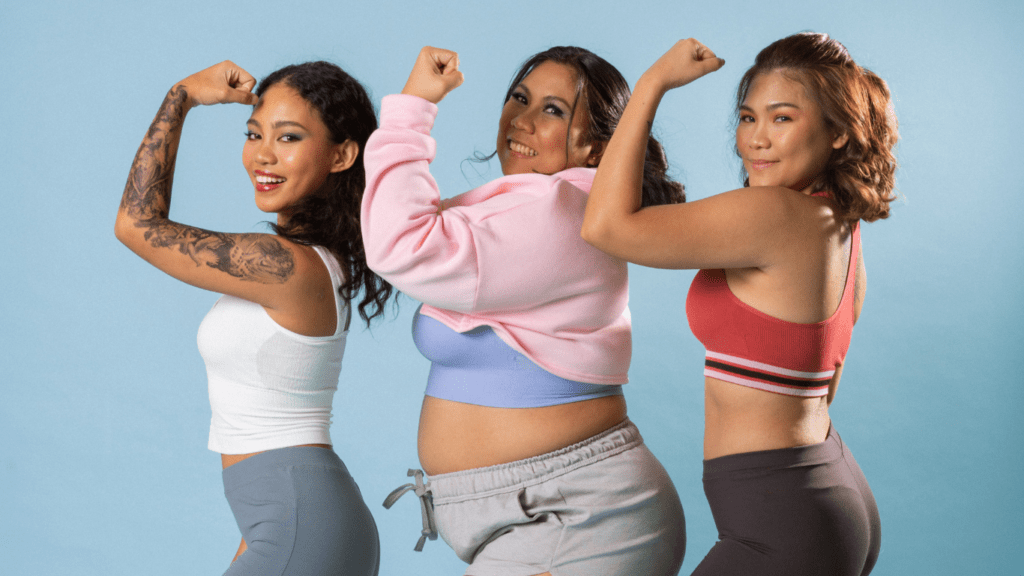 three girls showing their biceps