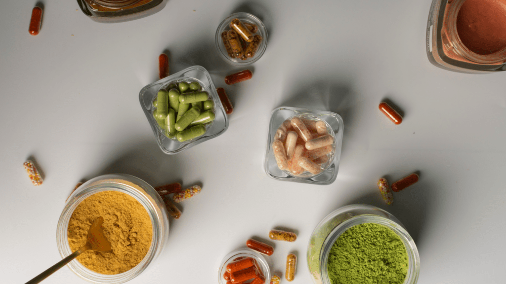 various vitamins and supplements on a wooden table