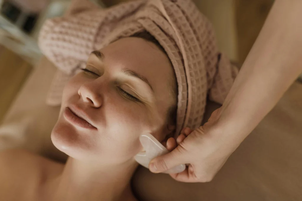 A serene facial massage session using a gua sha tool for skin rejuvenation and relaxation.